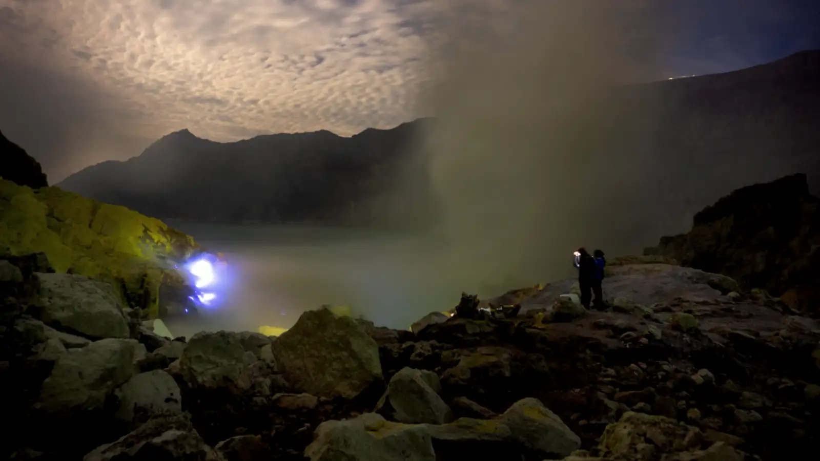 Close up view of the turquoise acid lake at Ijen Crater with sulfur smoke