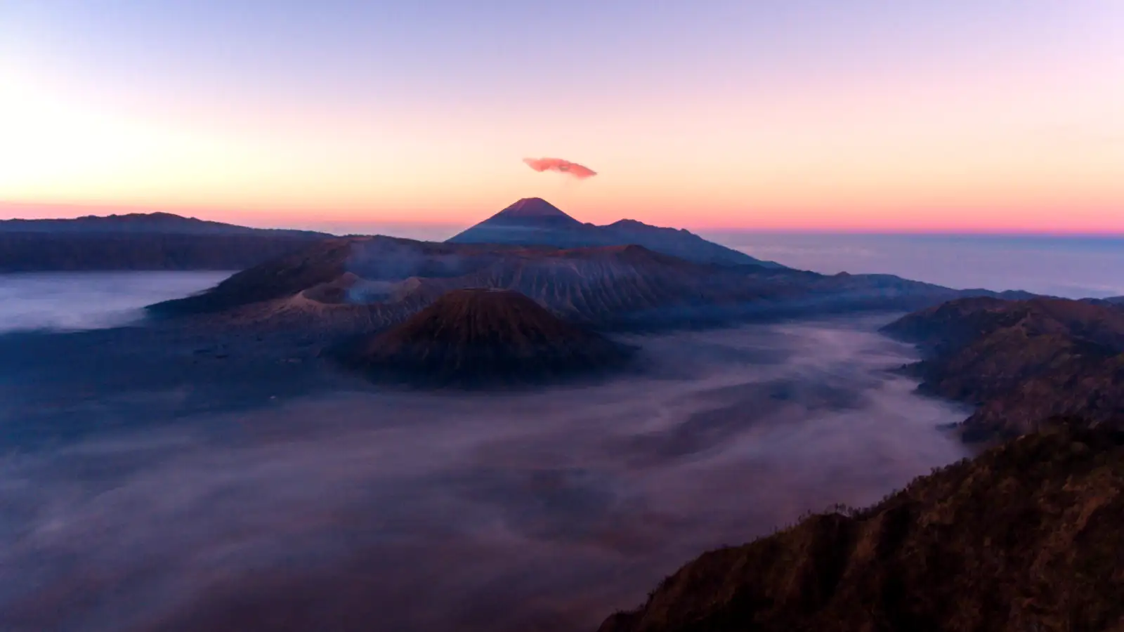 4WD Jeep Logistics Bromo Jeeps parked at the base of the Bromo crater during sunrise