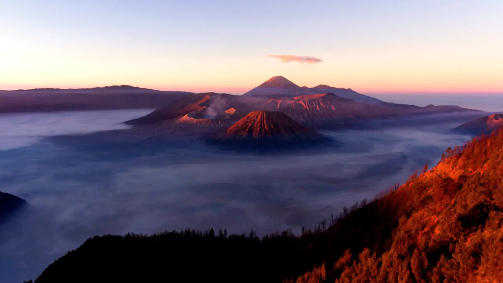 Ijen Crater Volcano Landscape Stunning turquoise acid lake and sulfur clouds at Ijen Crater during sunrise