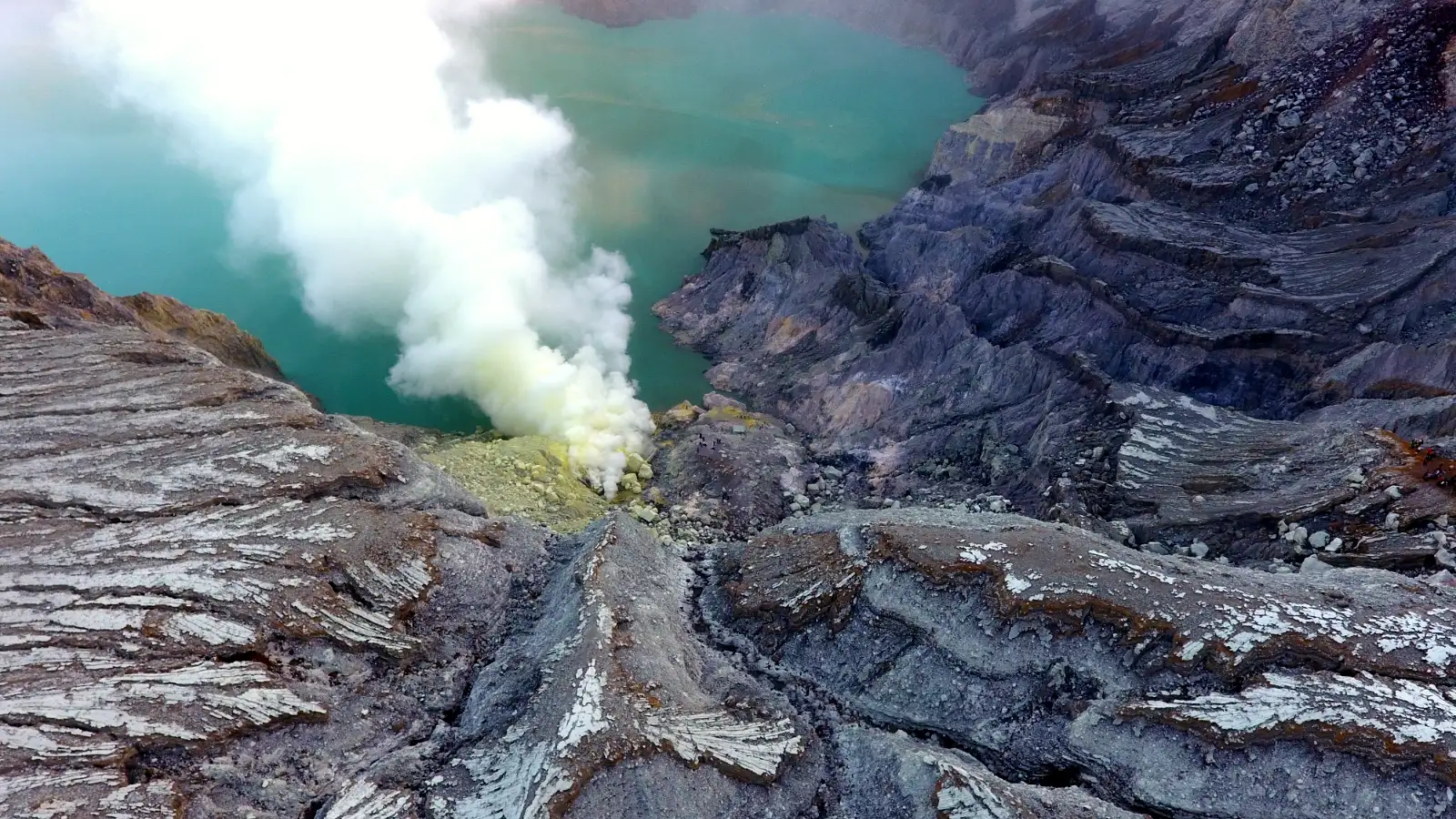 Sulfur miners carrying heavy baskets at Ijen volcano