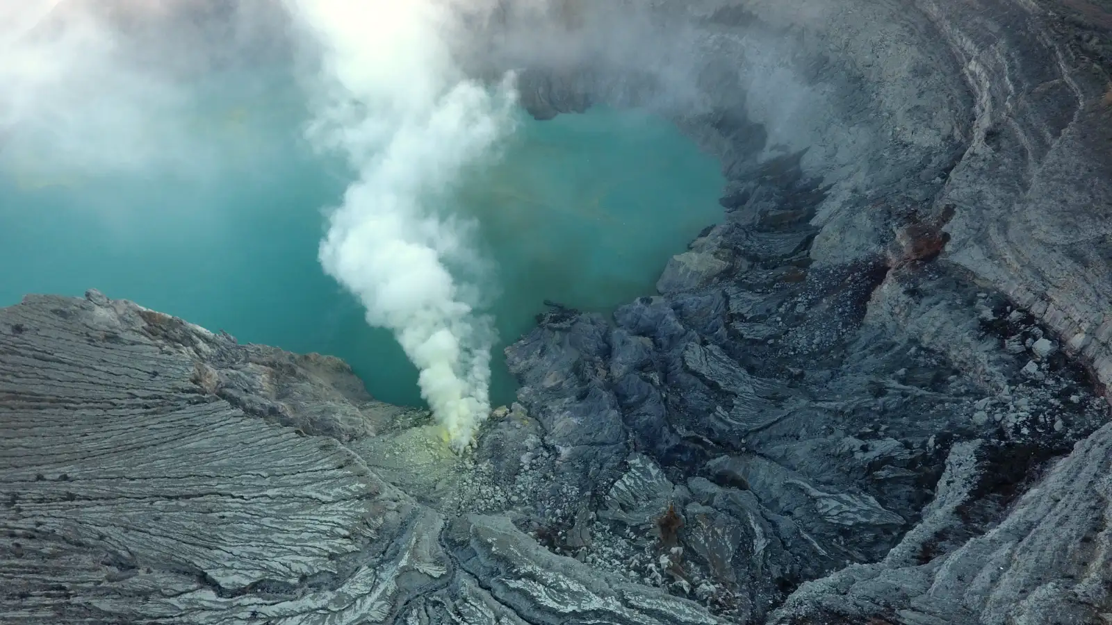 Sulfur miners carrying baskets at Ijen Crater