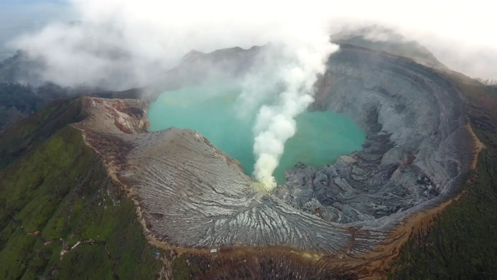 Stunning view of the turquoise Ijen Crater Lake at sunrise
