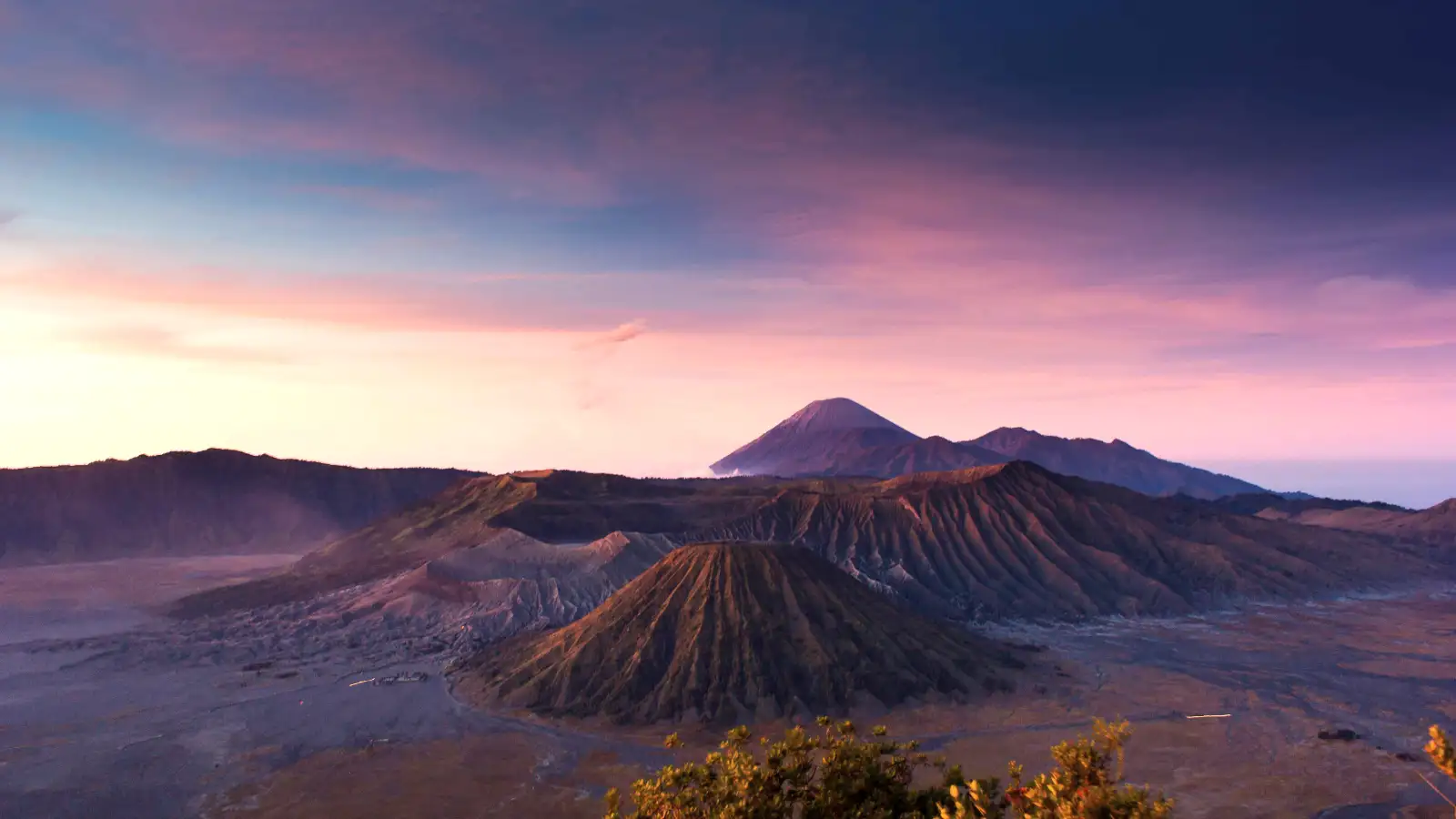 4WD Jeep parked in front of Mount Bromo during sunrise