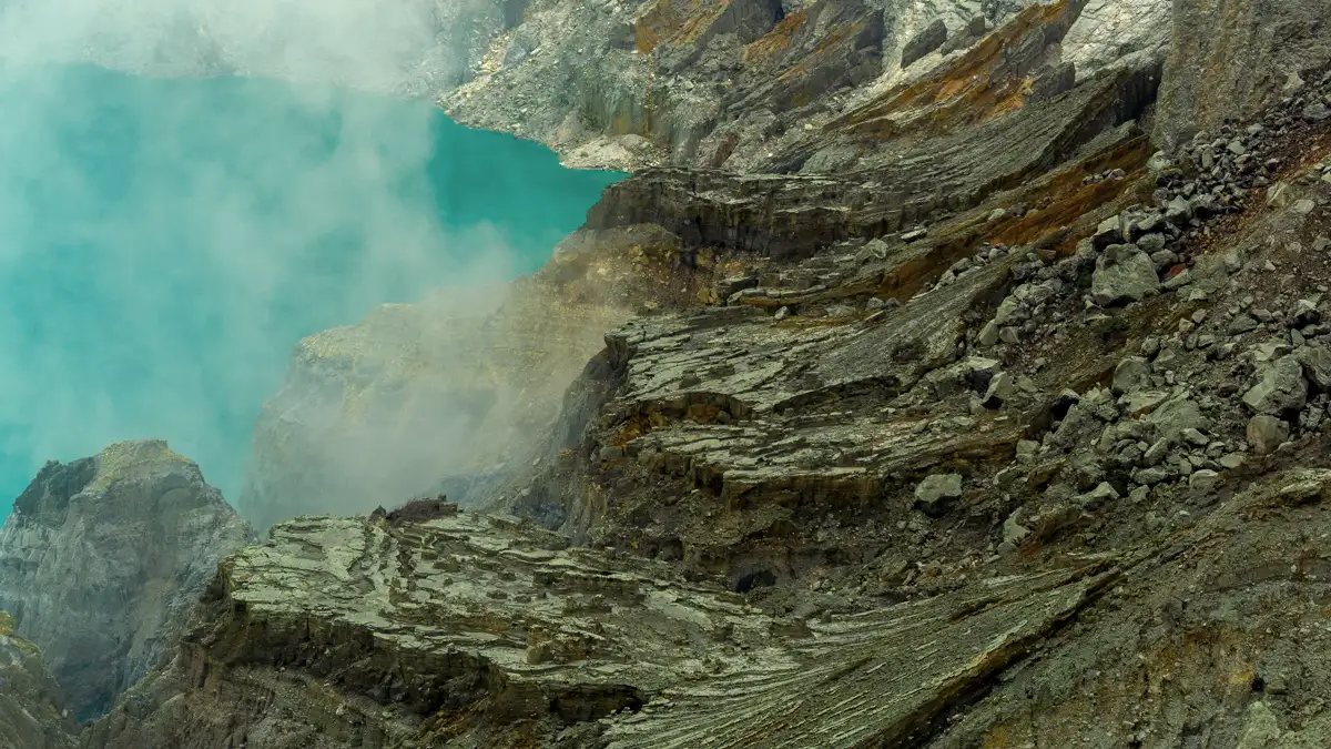 The Steep Hike to Ijen Rim Travelers hiking up the steep sandy path to Mount Ijen summit