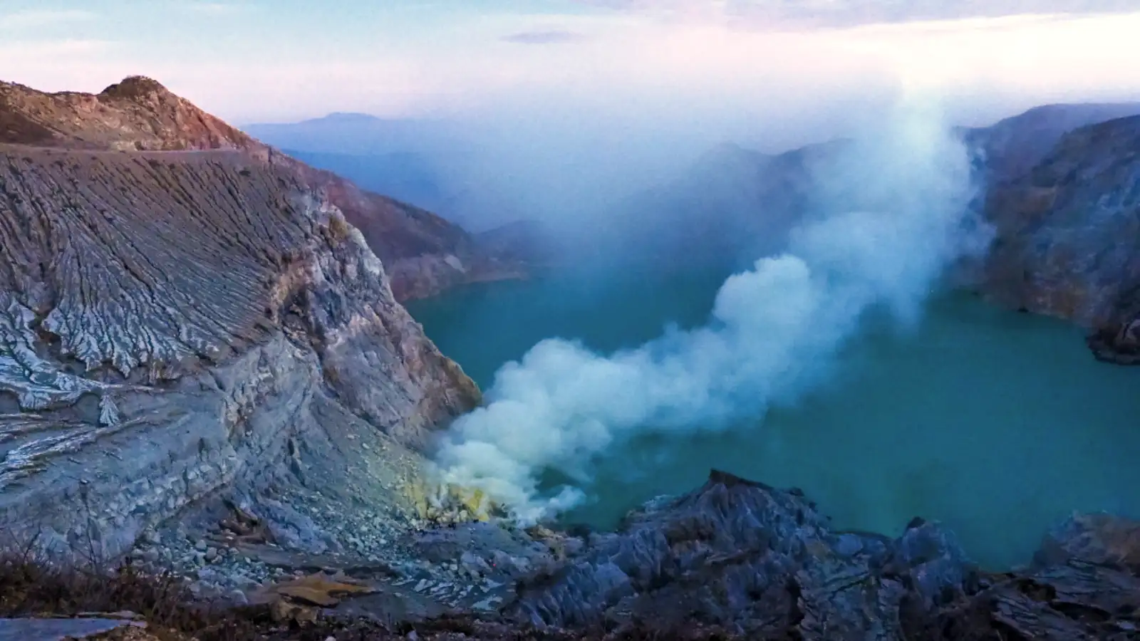 Sulfur gas rising from Ijen Crater lake at sunrise
